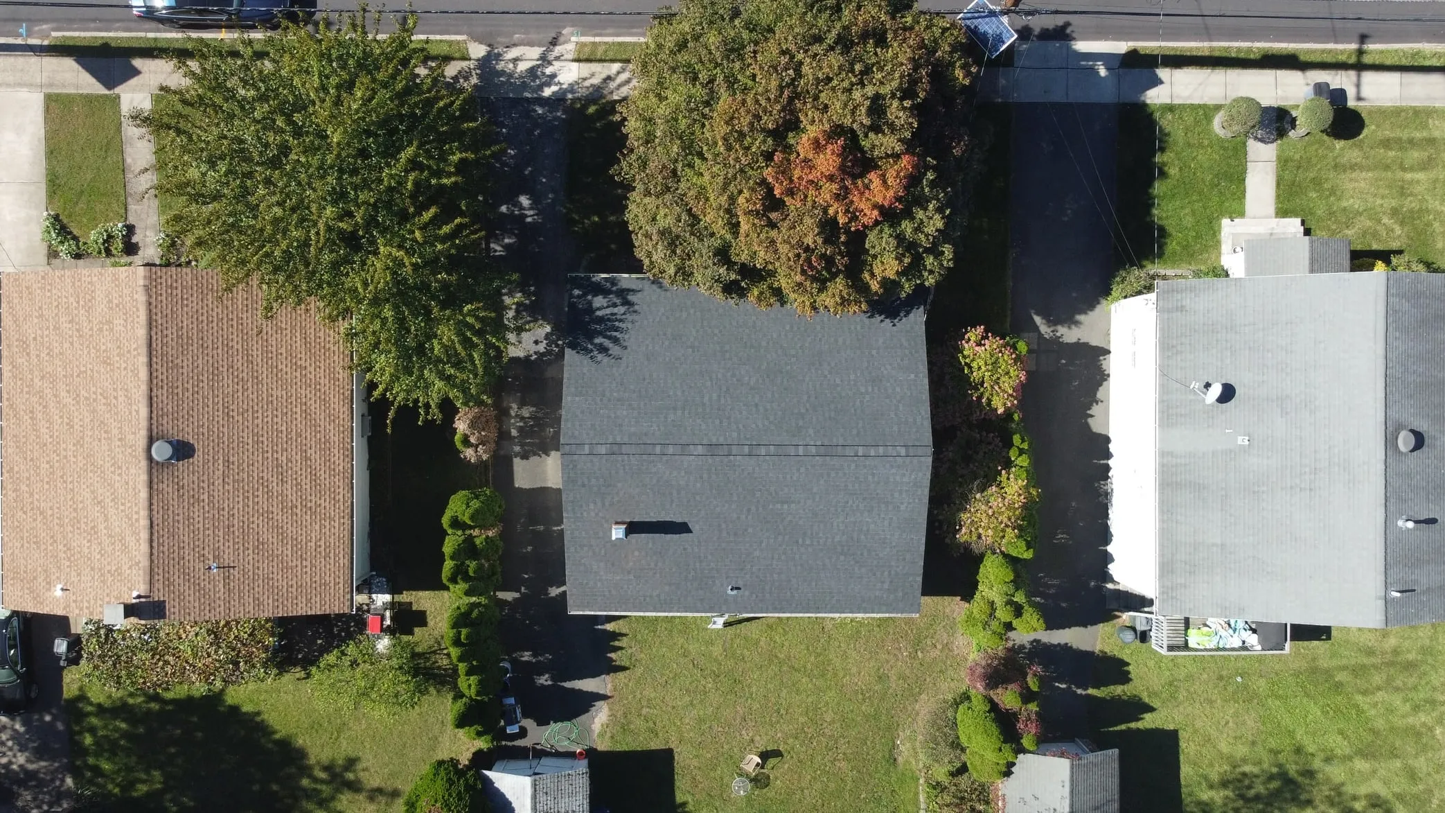 The same home from above with a finished charcoal architectural shingle roof
